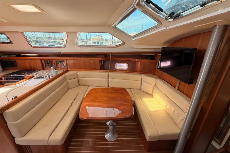 Slide: The Image of Luxurious interior of 2007 Hunter 44 Deck Salon with plush seating and elegant wood finishes. - 49