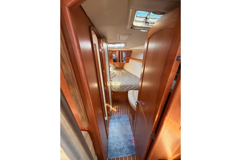 Slide: The Image of 2007 Hunter 44 Deck Salon interior with wood finish and cozy sleeping area. - 52