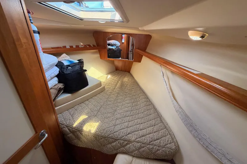 Slide: The Image of Cozy cabin interior of 2007 Hunter 44 Deck Salon sailboat with bedding and storage. - 54