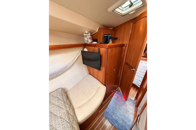 Slide: The Image of Interior of 2007 Hunter 44 Deck Salon with cozy seating and wooden cabinetry. - 57