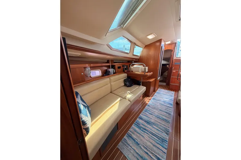 Slide: The Image of Interior of 2007 Hunter 44 Deck Salon with elegant wood finish and cozy seating. - 58