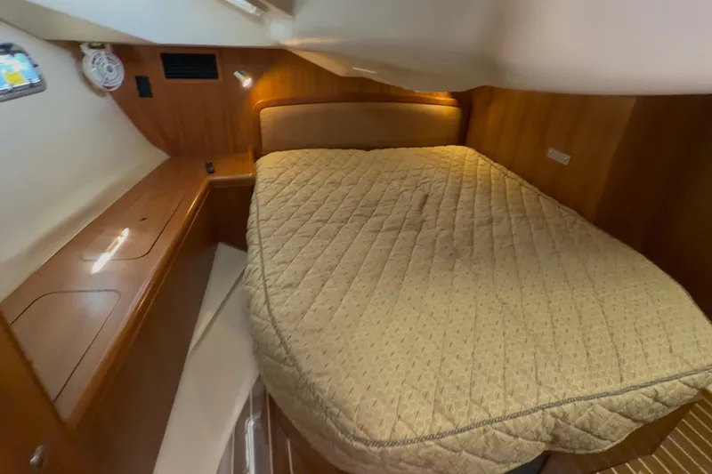 Slide: The Image of Luxurious cabin interior of 2007 Hunter 44 Deck Salon with cozy bed and wooden furnishings. - 61