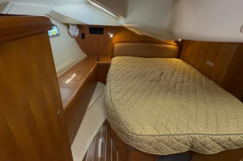 Slide: The Image of Cozy cabin interior of 2007 Hunter 44 Deck Salon with wood finish and comfortable bedding. - 62