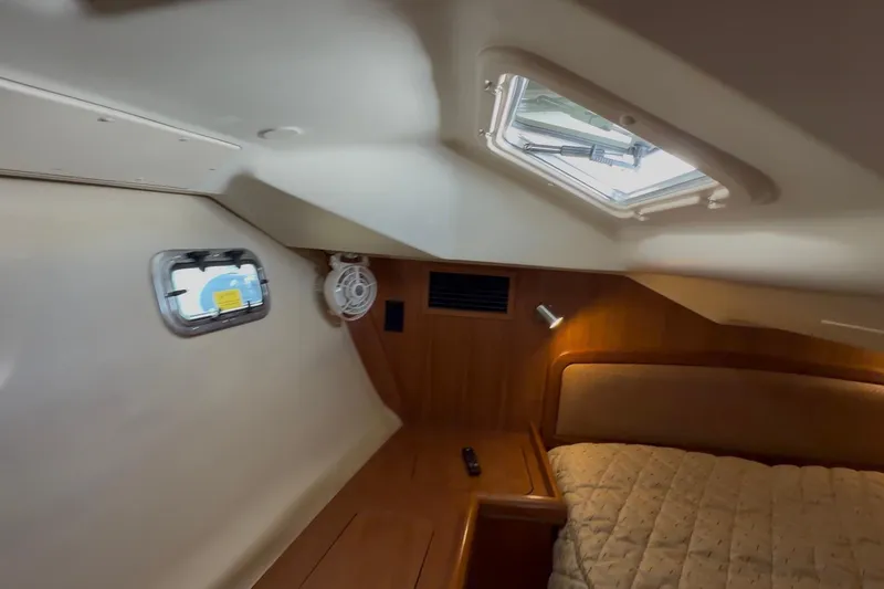 Slide: The Image of Cozy interior of 2007 Hunter 44 Deck Salon with bed, porthole, and skylight. - 64
