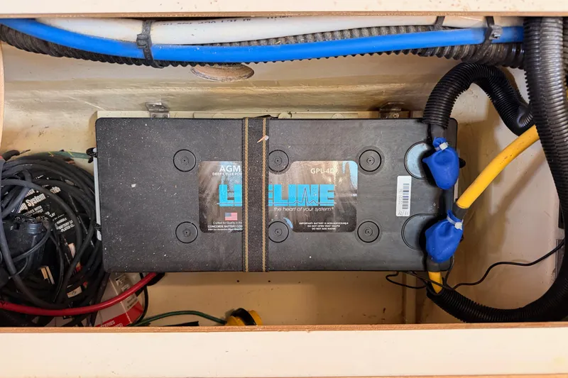 Slide: The Image of AGM battery in 2007 Hunter 44 Deck Salon sailboat, secured with cables and straps. - 70