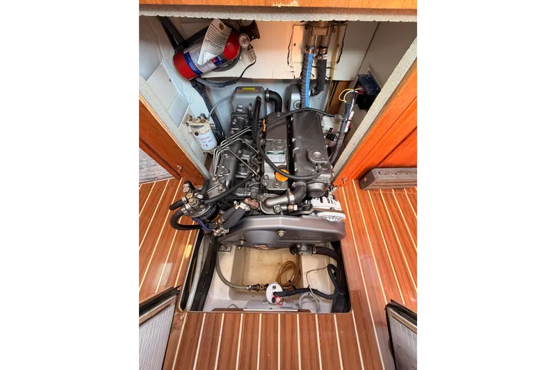 Slide: The Image of Engine compartment of 2007 Hunter 44 Deck Salon with visible components and wooden flooring. - 72
