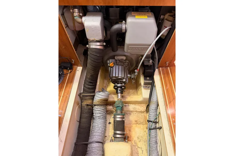 Slide: The Image of Engine compartment of a 2007 Hunter 44 Deck Salon sailboat, featuring a Yanmar engine. - 74