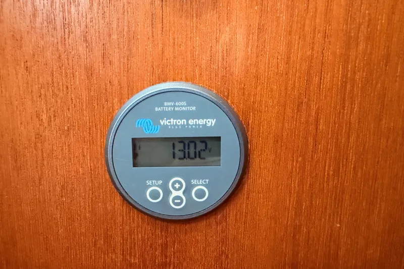 Slide: The Image of Victron Energy battery monitor on 2007 Hunter 44 Deck Salon, displaying 13.02 volts. - 75