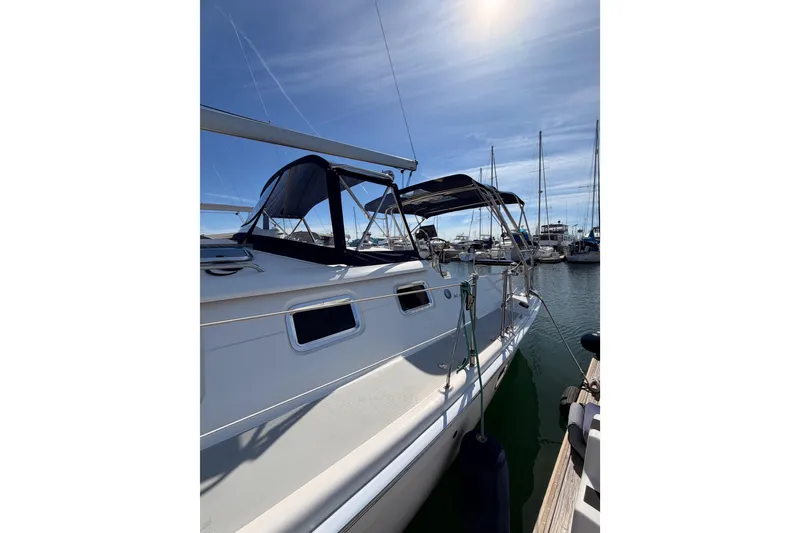 Slide: The Image of 2007 Hunter 44 Deck Salon sailboat docked in a sunny marina. - 9