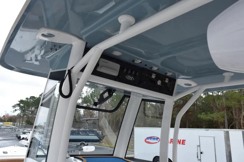 Slide: The Image of 2022 Sea Hunt Ultra 275 SE boat interior with control panel and canopy. - 10