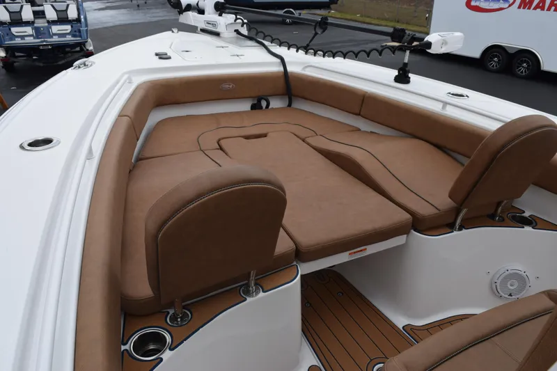 Slide: The Image of 2022 Sea Hunt Ultra 275 SE boat interior with tan seating and white deck. - 12