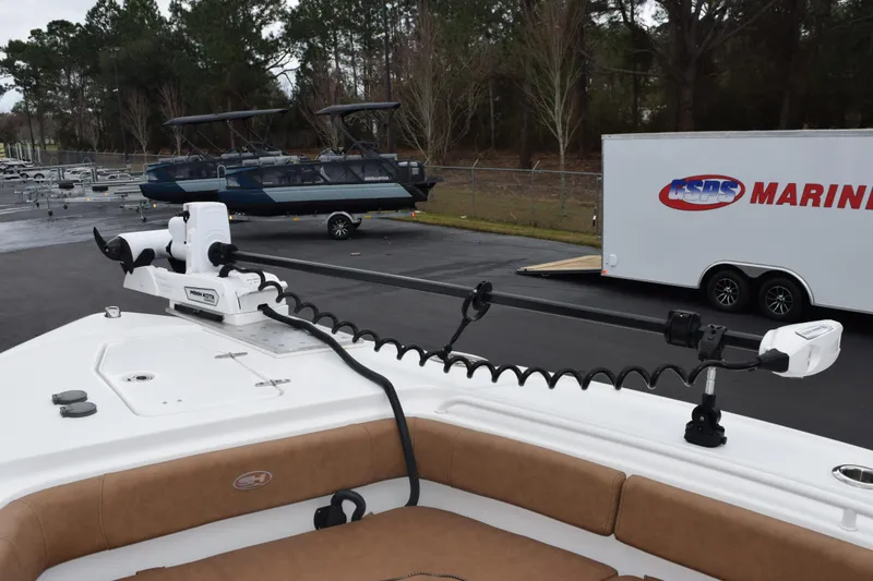 Slide: The Image of 2022 Sea Hunt Ultra 275 SE boat with Minn Kota trolling motor in marina setting. - 13