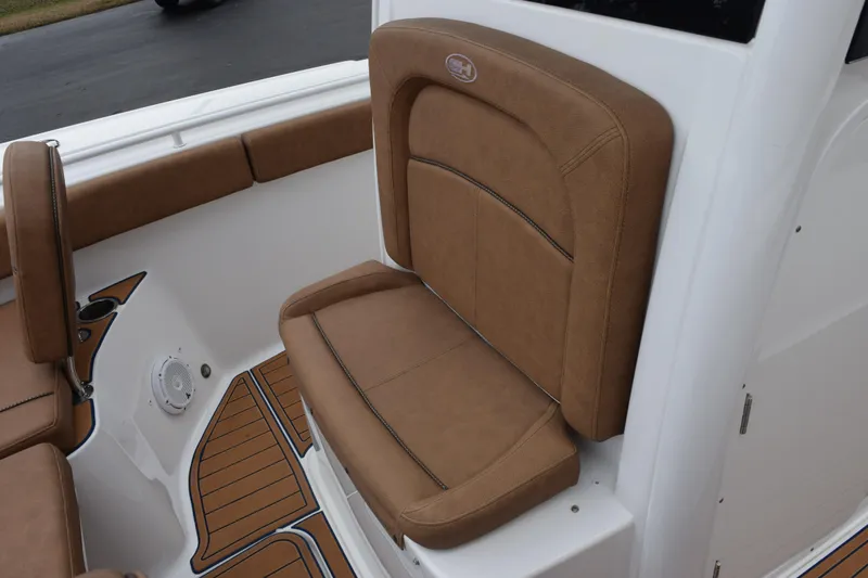 Slide: The Image of 2022 Sea Hunt Ultra 275 SE boat with tan cushioned seating and teak-style flooring. - 14