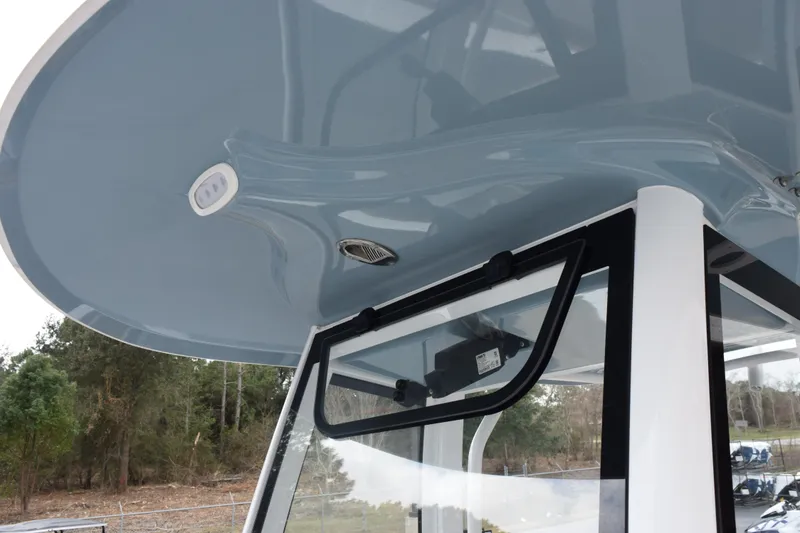 Slide: The Image of 2022 Sea Hunt Ultra 275 SE boat with sleek blue canopy and modern design. - 15