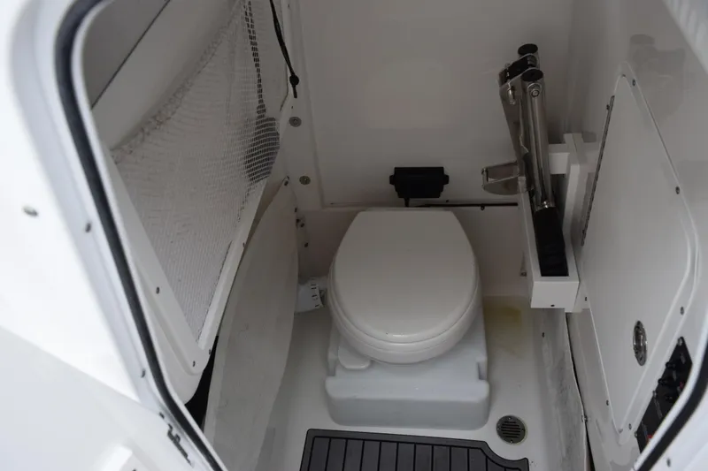 Slide: The Image of 2022 Sea Hunt Ultra 275 SE boat interior with compact marine toilet. - 17
