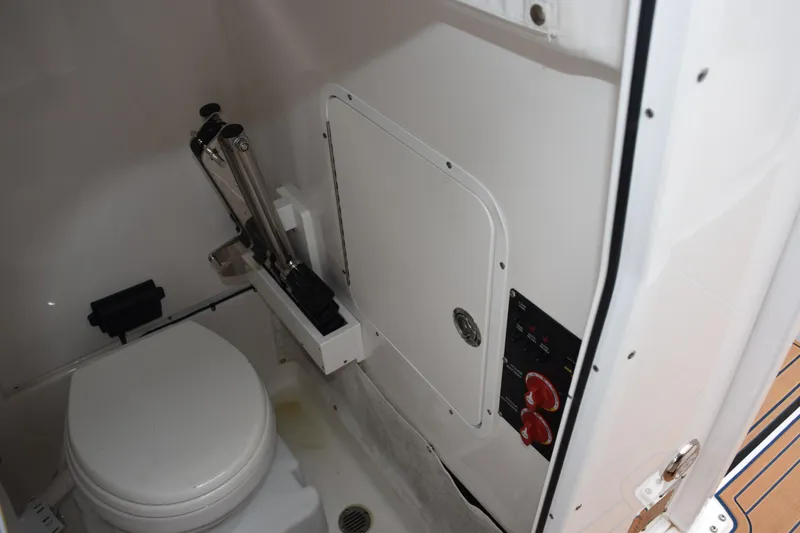 Slide: The Image of 2022 Sea Hunt Ultra 275 SE boat interior with toilet and control panel. - 18