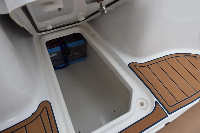 Slide: The Image of Battery compartment of 2022 Sea Hunt Ultra 275 SE boat with wooden deck accents. - 20