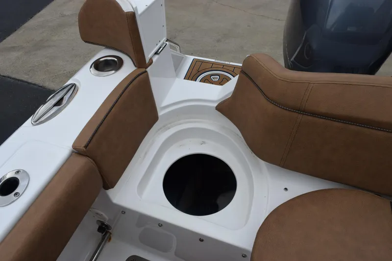 Slide: The Image of 2022 Sea Hunt Ultra 275 SE boat interior with tan seating and cup holders. - 24