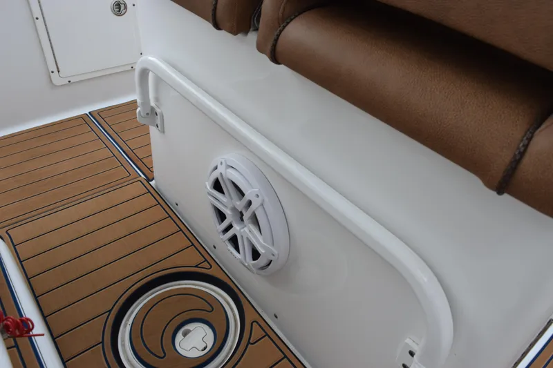 Slide: The Image of 2022 Sea Hunt Ultra 275 SE interior with brown seating and marine speaker. - 26