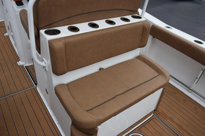 Slide: The Image of 2022 Sea Hunt Ultra 275 SE boat seating with cup holders and teak flooring. - 7