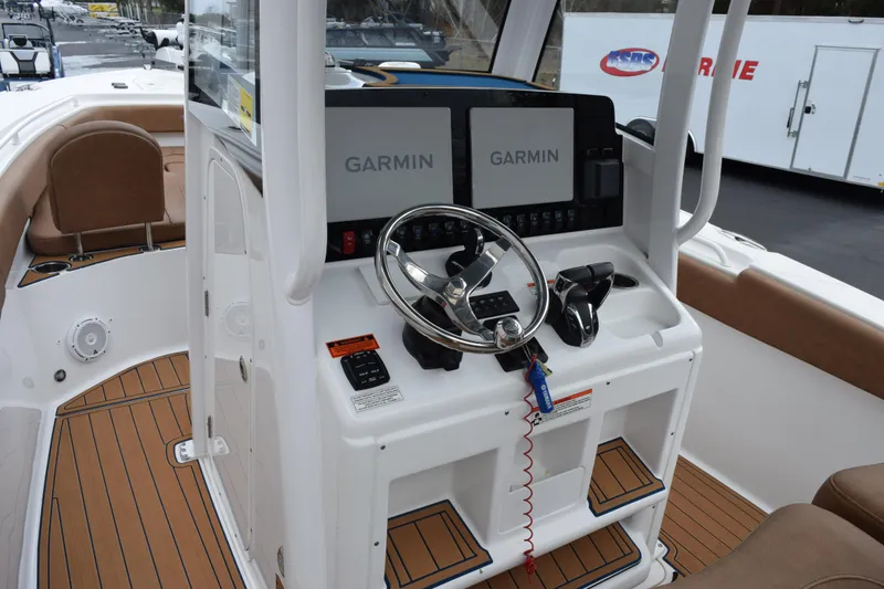 Slide: The Image of 2022 Sea Hunt Ultra 275 SE boat cockpit with Garmin navigation system and modern controls. - 9
