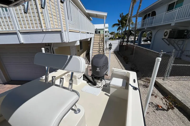 Slide: The Image of 2009 Parker 2300 Special Edition boat with Yamaha engine, docked near coastal homes. - 12