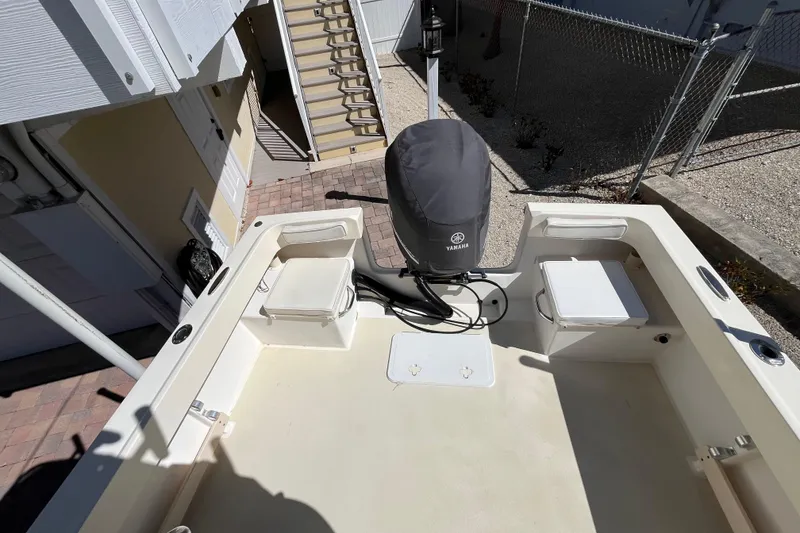 Slide: The Image of 2009 Parker 2300 Special Edition boat with Yamaha engine, docked near stairs. - 13