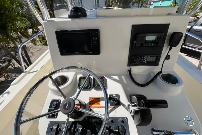 Slide: The Image of 2009 Parker 2300 Special Edition boat dashboard with steering wheel and navigation controls. - 14