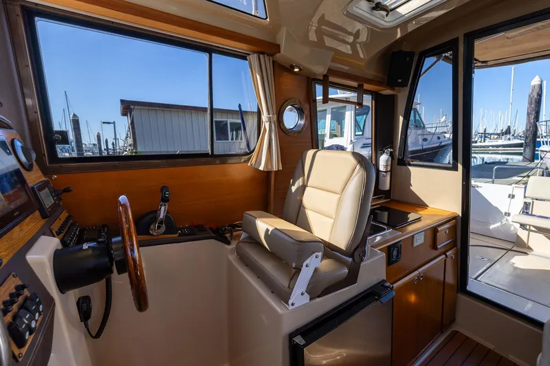 Slide: The Image of Interior of 2019 Ranger Tugs R-23 boat with helm station and seating. - 13