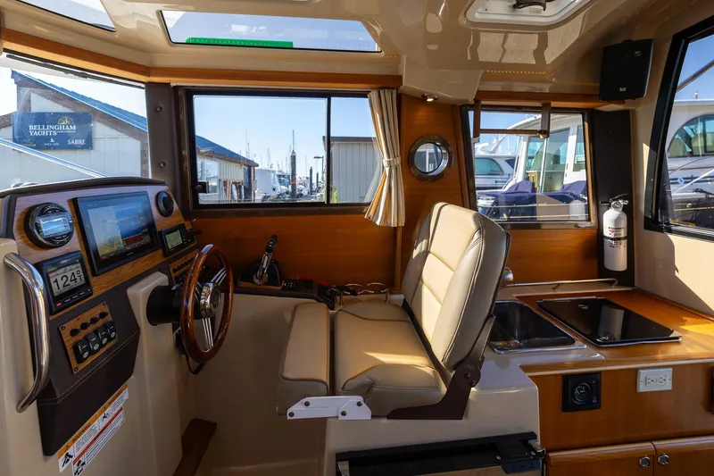 Slide: The Image of Interior of 2019 Ranger Tugs R-23 boat with helm, seating, and navigation equipment. - 14