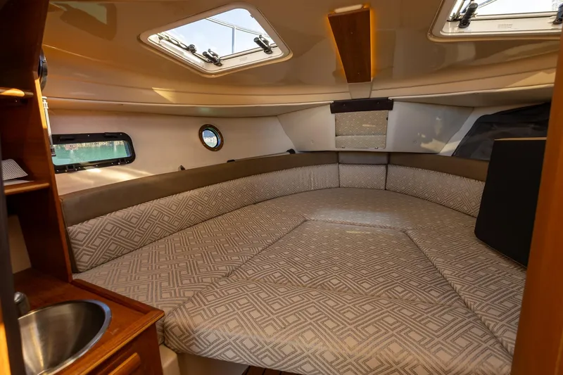 Slide: The Image of 2019 Ranger Tugs R-23 cabin interior with cozy seating and natural light. - 15