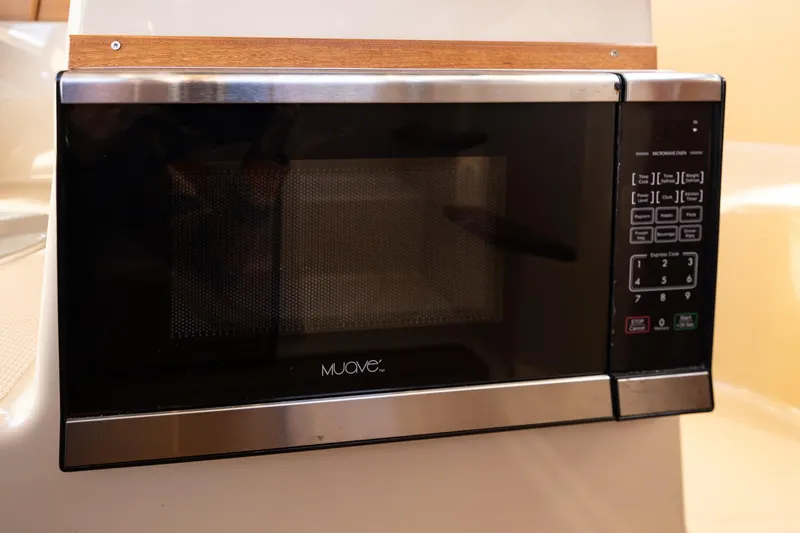 Slide: The Image of Microwave oven inside 2019 Ranger Tugs R-23 boat, featuring digital controls. - 19