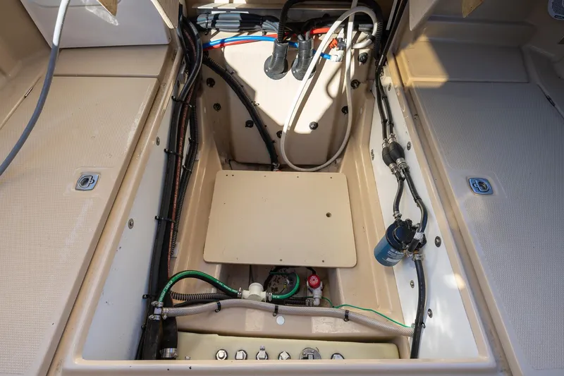 Slide: The Image of 2019 Ranger Tugs R-23 boat interior showing engine compartment and wiring. - 24