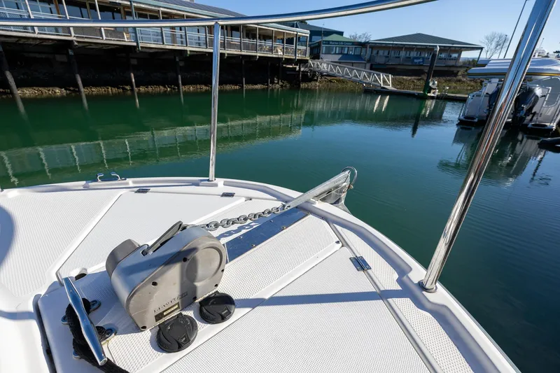 Slide: The Image of 2019 Ranger Tugs R-23 boat bow with anchor, docked in marina. - 25