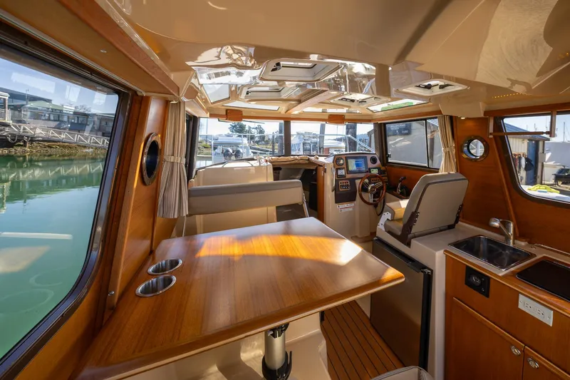 Slide: The Image of Interior of 2019 Ranger Tugs R-23 boat with wood finishes and modern amenities. - 5