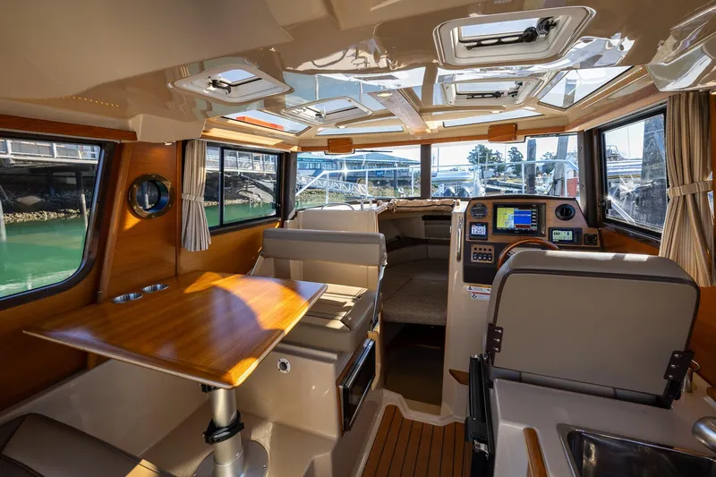 Slide: The Image of Interior of 2019 Ranger Tugs R-23 boat with wood accents and modern navigation equipment. - 6