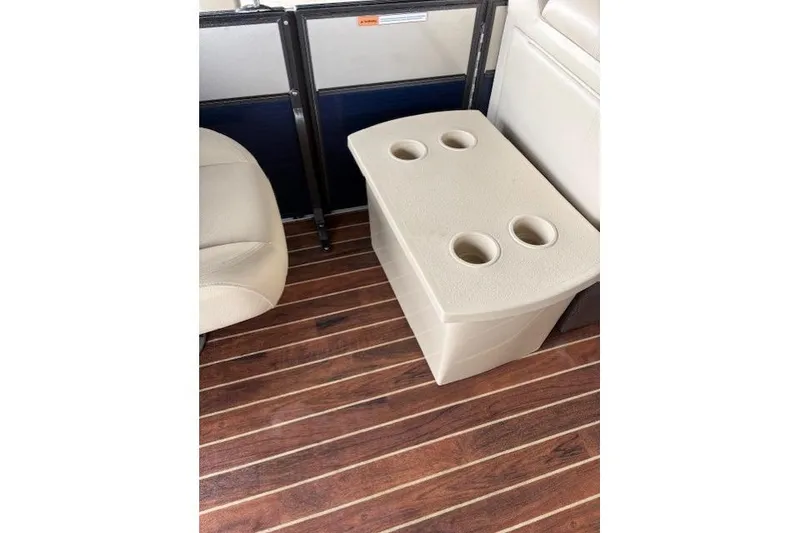 Slide: The Image of 2016 Crest 230 Caribbean SLR CP3 boat interior with cup holder and wood flooring. - 10