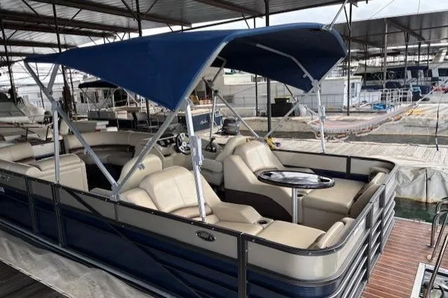 Slide: The Image of 2016 Crest 230 Caribbean SLR CP3 pontoon boat with blue canopy and beige seating. - 3