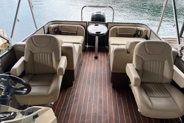 Slide: The Image of 2016 Crest 230 Caribbean SLR CP3 boat interior with beige seating and wood flooring. - 4