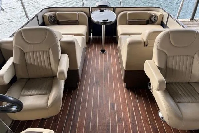 Slide: The Image of 2016 Crest 230 Caribbean SLR CP3 boat interior with beige seating and wooden flooring. - 5