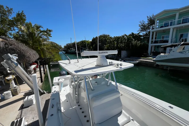 Slide: The Image of 2016 SeaHunter 35 Tournament boat docked by waterfront homes, featuring Garmin equipment. - 10