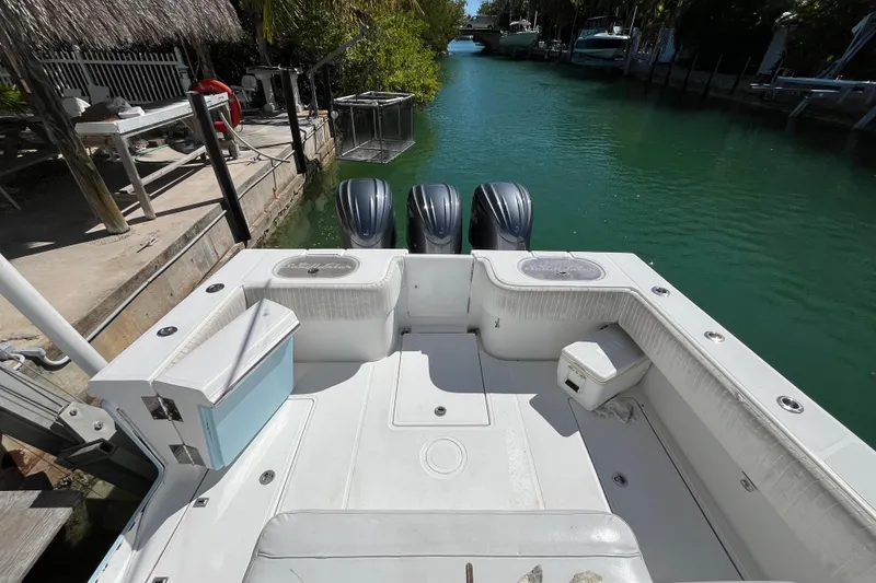 Slide: The Image of 2016 SeaHunter 35 Tournament boat with triple engines docked in a serene canal. - 16