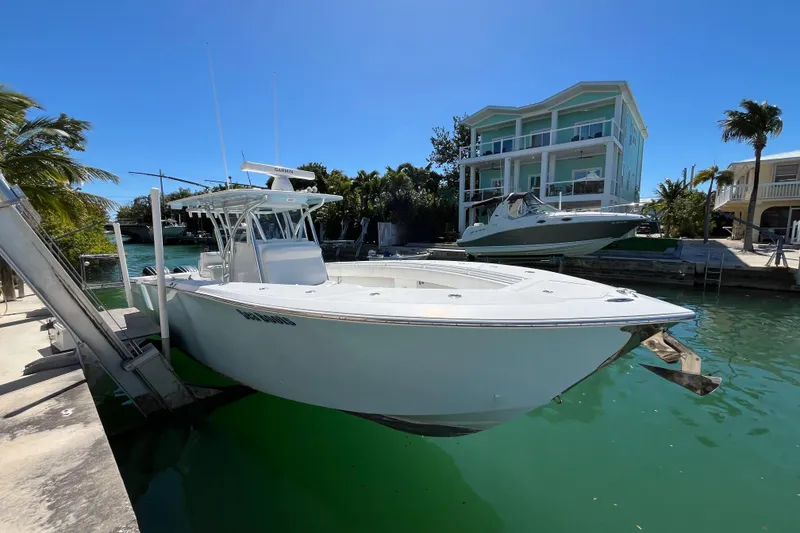 Slide: The Image of 2016 SeaHunter 35 Tournament boat docked near waterfront homes, under clear blue sky. - 4