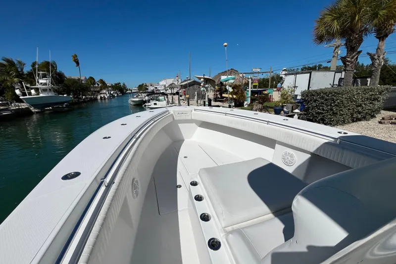 Slide: The Image of 2016 SeaHunter 35 Tournament boat docked in a scenic marina under clear blue skies. - 8