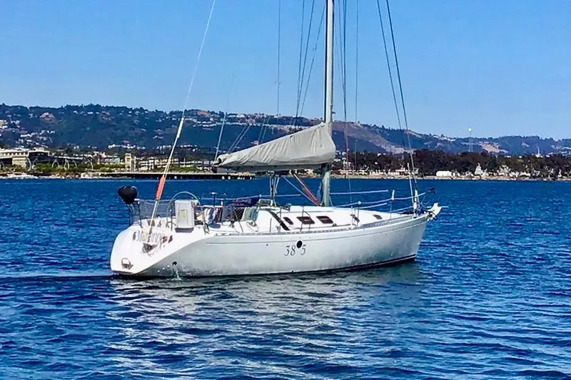 Slide: The Image of Sailboat on water, 1991 Beneteau First 38s5, scenic coastal background. - 1