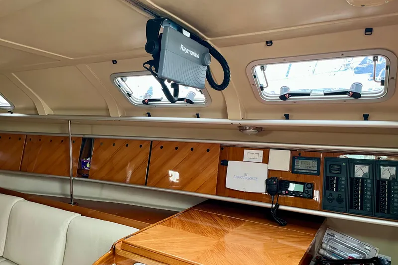 Slide: The Image of Interior of 1991 Beneteau First 38s5 yacht with navigation equipment and wooden paneling. - 10
