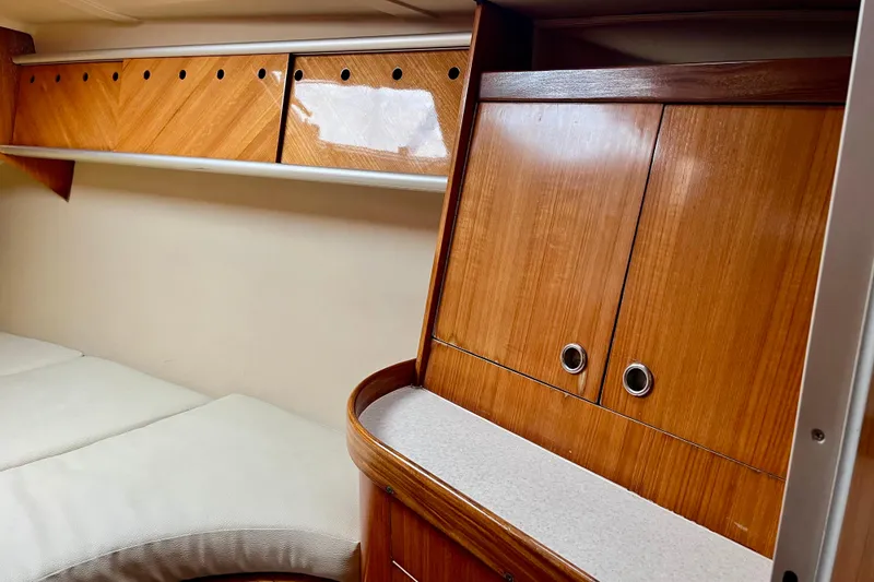 Slide: The Image of Interior of 1991 Beneteau First 38s5 yacht with wooden cabinetry and cushioned seating. - 13