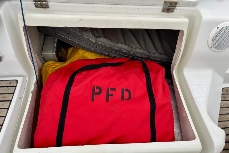 Slide: The Image of Red PFD bag in storage compartment of 1991 Beneteau First 38s5 sailboat. - 16