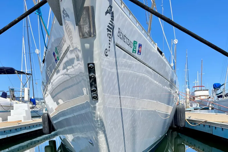 Slide: The Image of 1991 Beneteau First 38s5 sailboat docked at marina, reflecting on water. - 19
