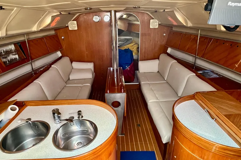Slide: The Image of Luxurious interior of 1991 Beneteau First 38s5 yacht with elegant wood and white seating. - 2